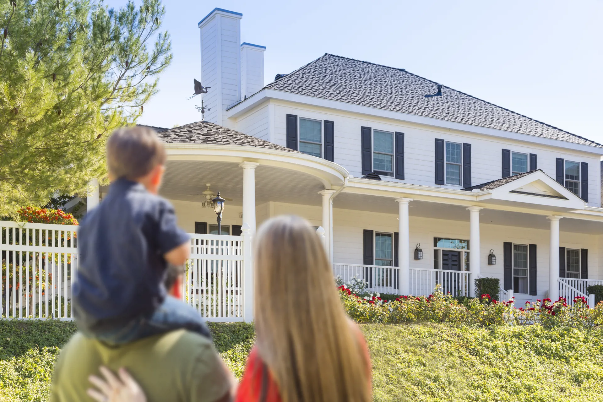 family looking at house from the outside