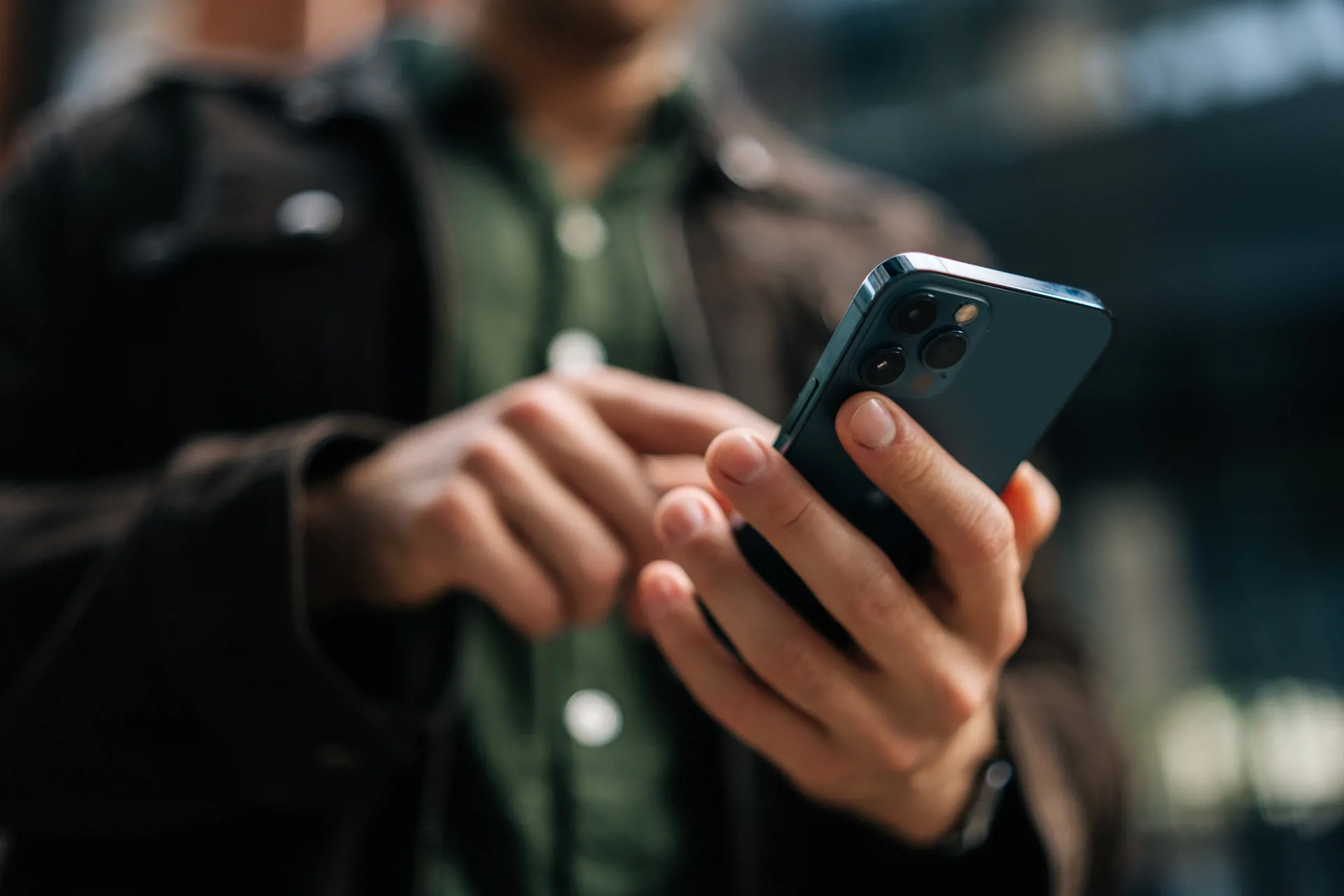 Hands with mobile phone displaying alert