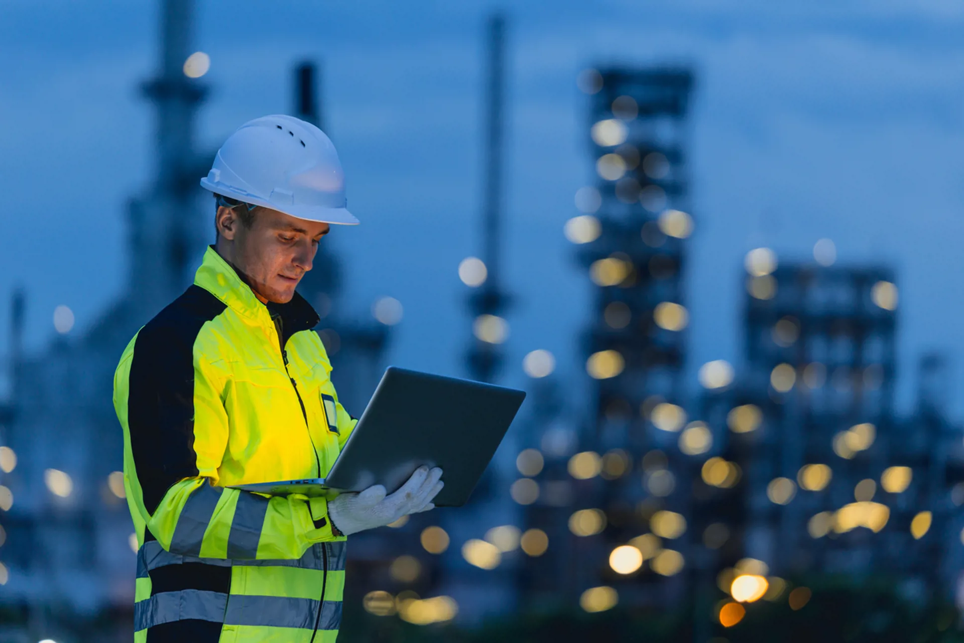 Engineer man technician male working at night shift with tablet technology device on site service