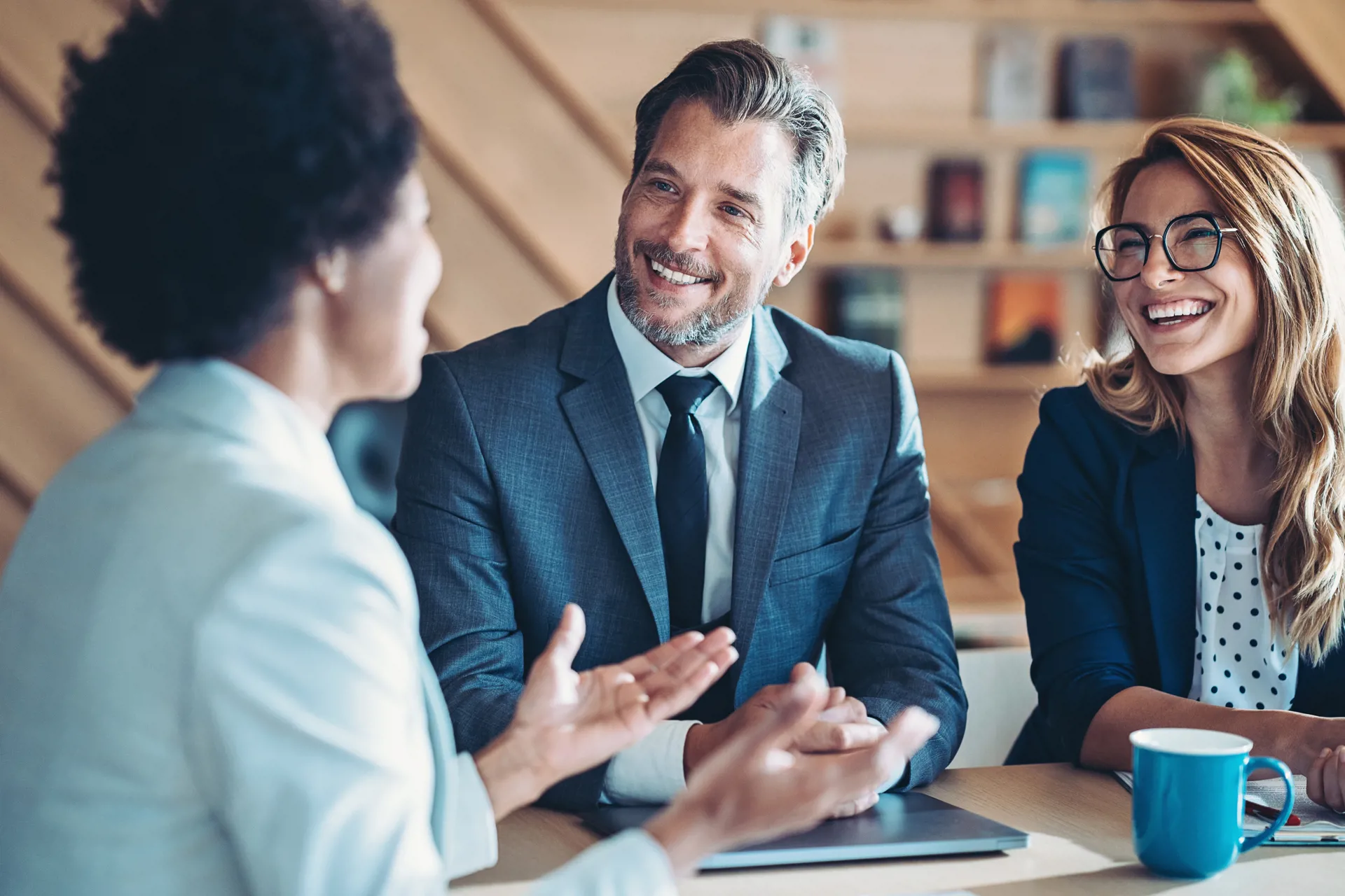 Three people smiling and talking