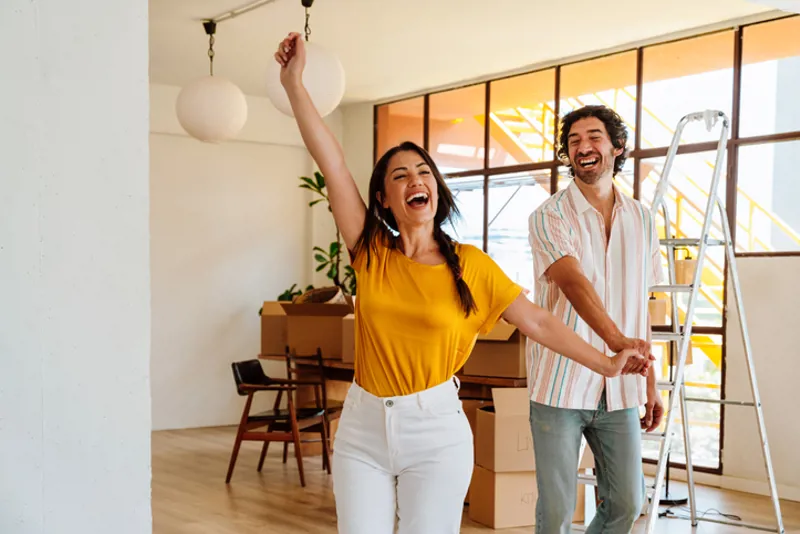 Happy young couple relocating in a new apartment