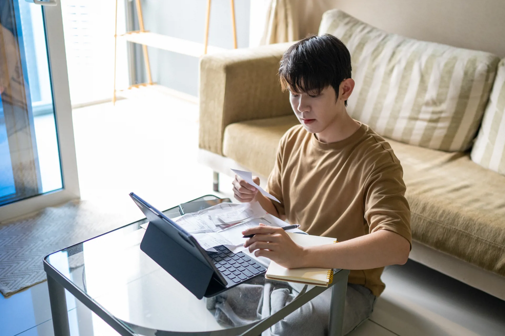 Young Man Calculating Expenses