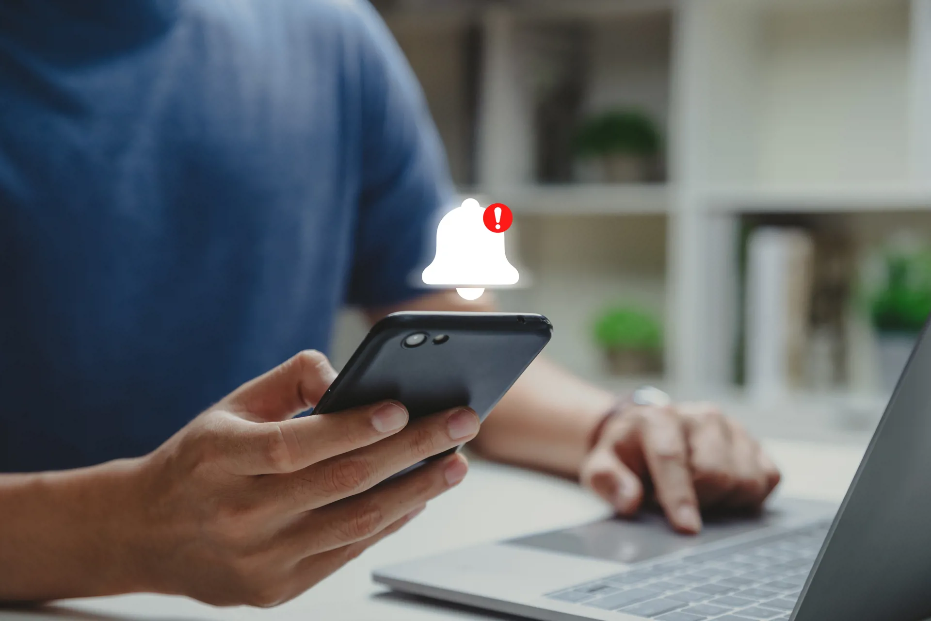 man holding mobile phone with alert graphic