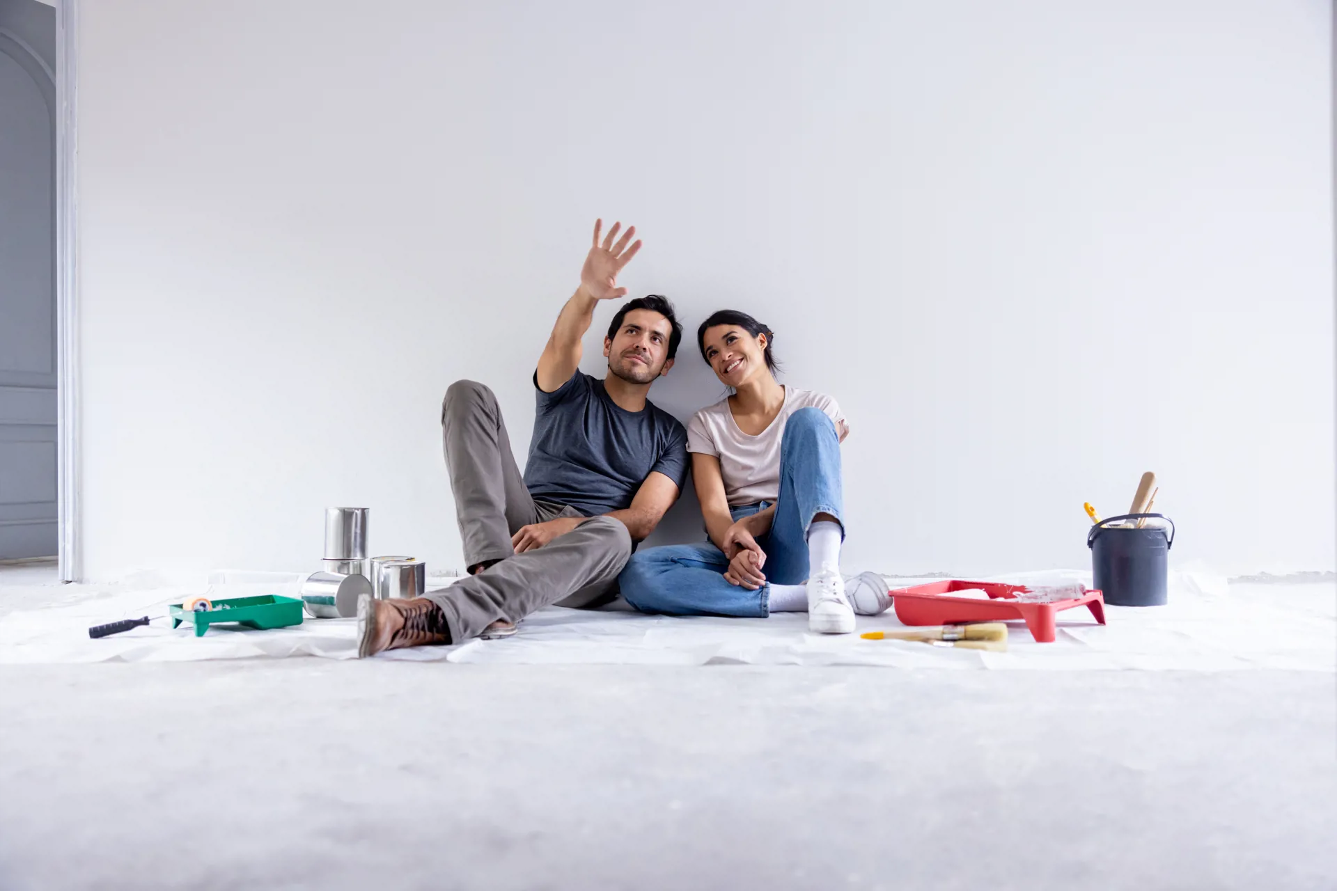 Couple in bed reviewing tablet