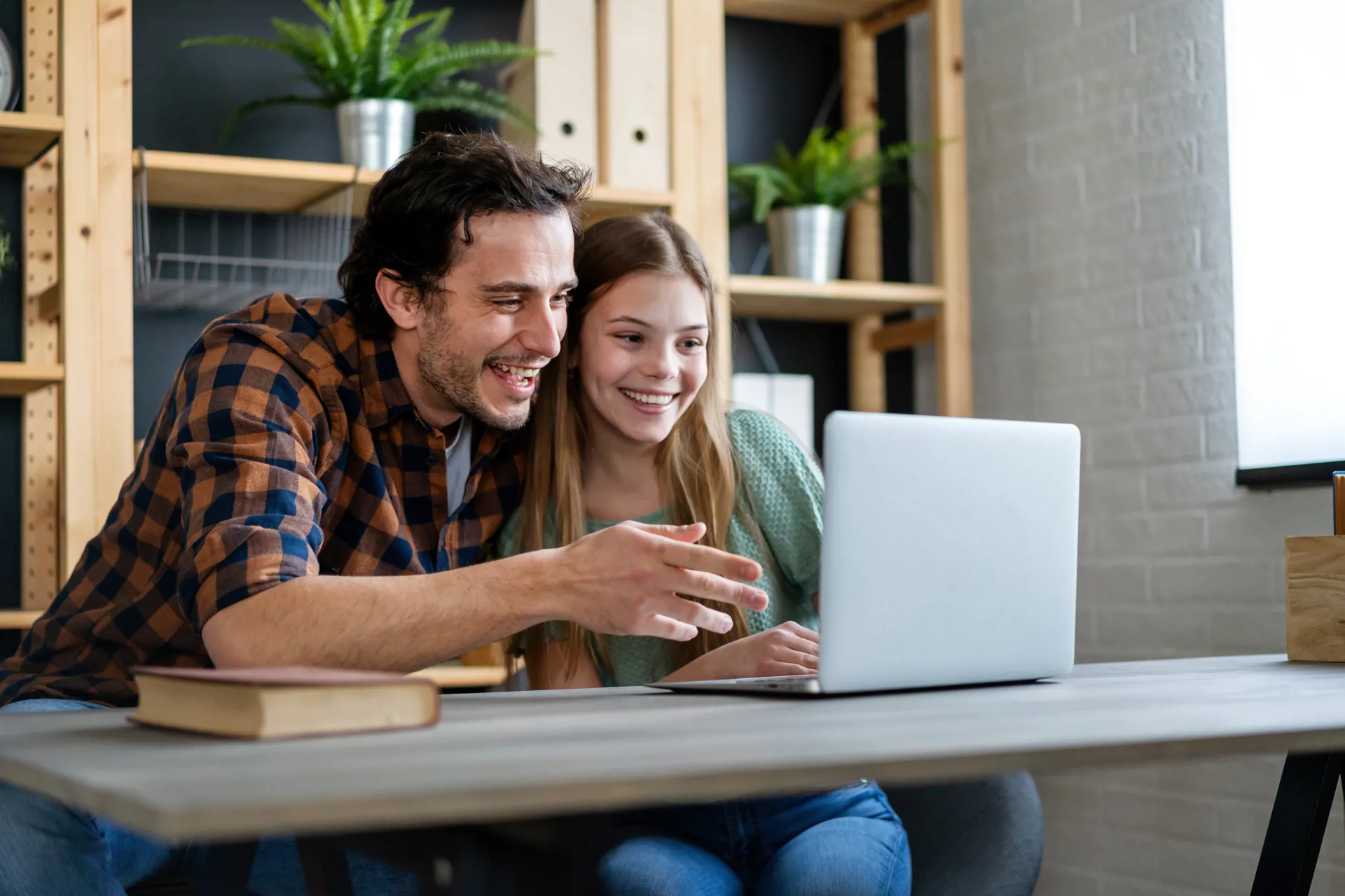 Parent looking at computer with kid